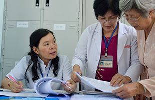 Healthcare workers reviewing files together