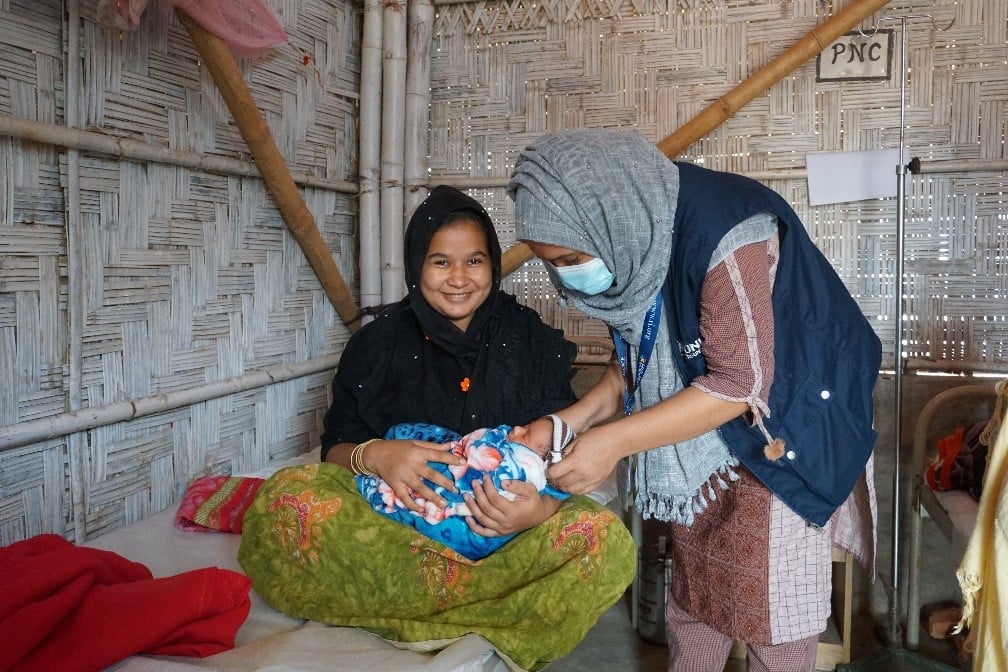 Midwife attends to a mother and her newborn